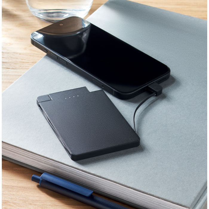 Powerbank och telefon på ett skrivbord